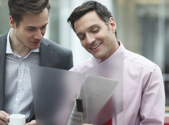 Business colleagues holding files in meeting Business colleagues holding files in meeting