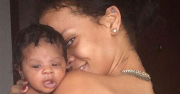 Semi-naked Rihanna cuddles up to her baby niece in candid 