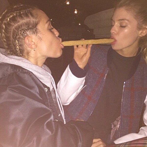 Miley Cyrus packs on the PDA with Victorias Secret model 