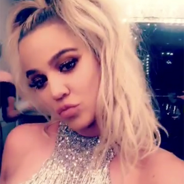 Khloe Kardashian Rubs Baby Bump in Sparkling Outfit at Family Christmas Party