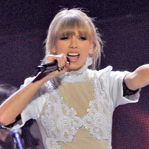 Taylor Swift Performs in White Wedding Dress at Brit Awards, Strips ...