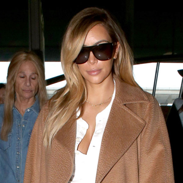 Kim Kardashian Shows Off Feather Boa & Skirt While Leaving Paris