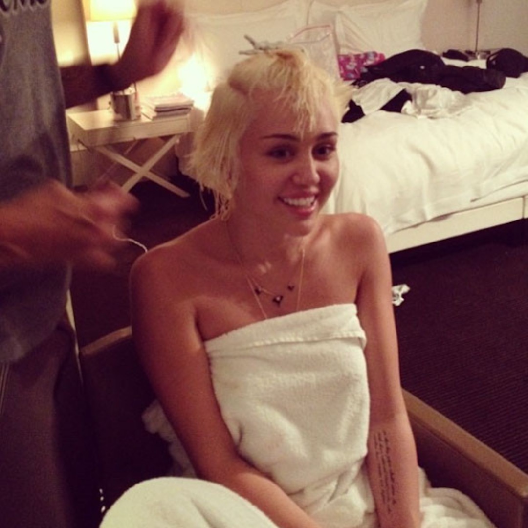 Miley Cyrus stuns crowd over topless photo in bed with dogs
