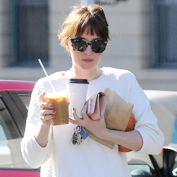 Look: Dakota Johnson Has Her Hands Full - E! Online