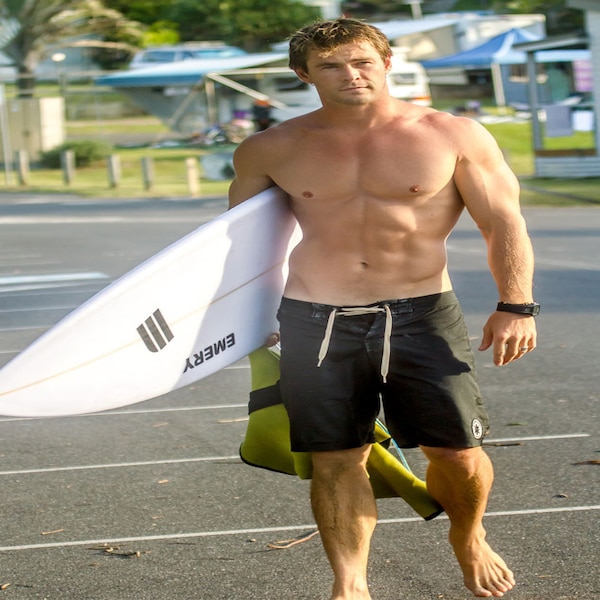 Surfing from Chris Hemsworth's 32 Hottest Pics | E! News