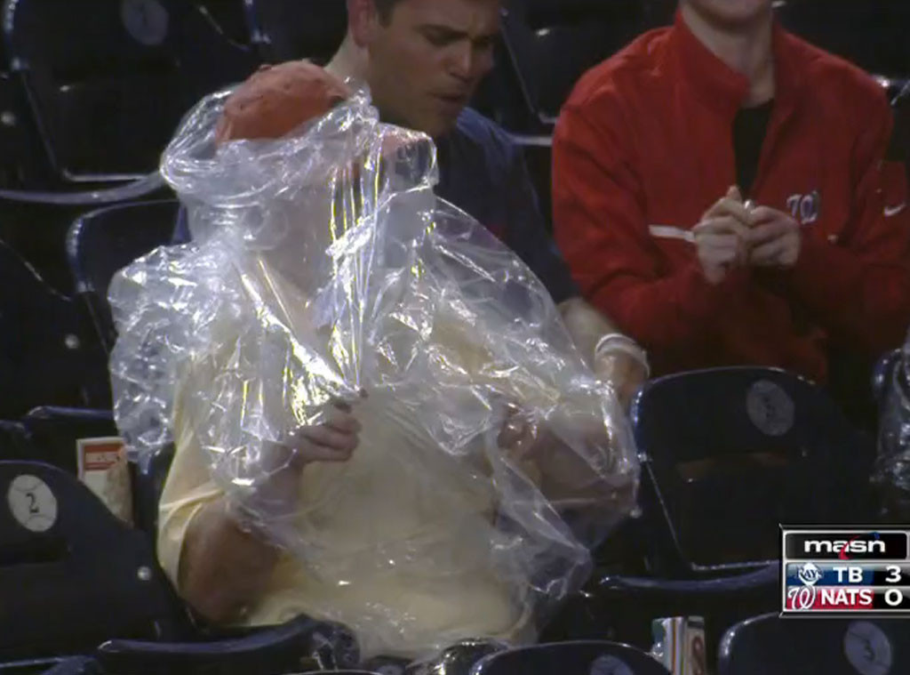 Fan struggles to put on poncho at Fenway Park 