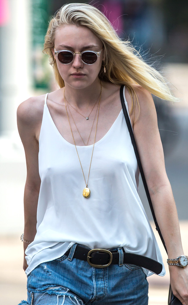 Dakota Fanning flashes her black bra under white shirt in New York