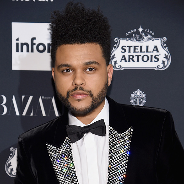 The Weeknd walked the red carpet in a classic Valentino black suit and  bowtie. He added an oversize flower brooch as a final accent – replay254