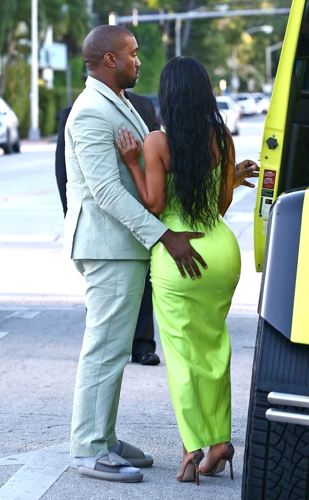 Kim Kardashian is lifted out of her G wagon by husband Kanye West as she  wows in figure hugging neon dress