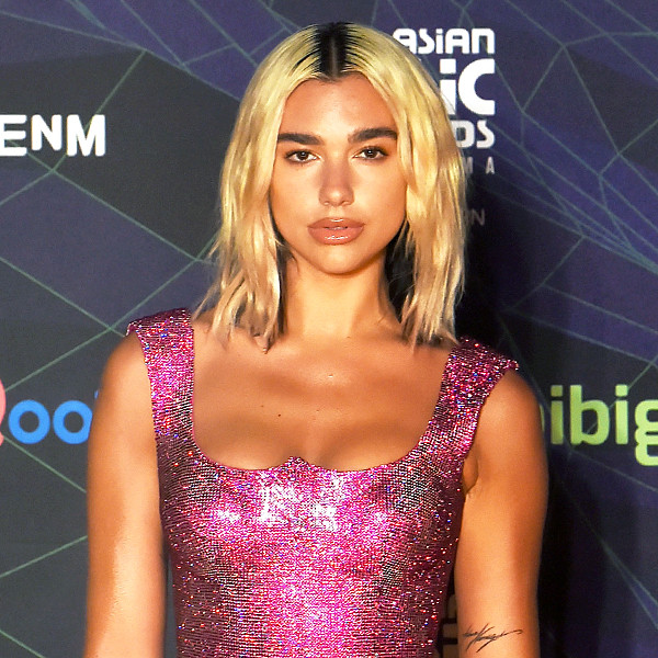 Dua Lipa makes a bold statement in a VERY sheer sparkling