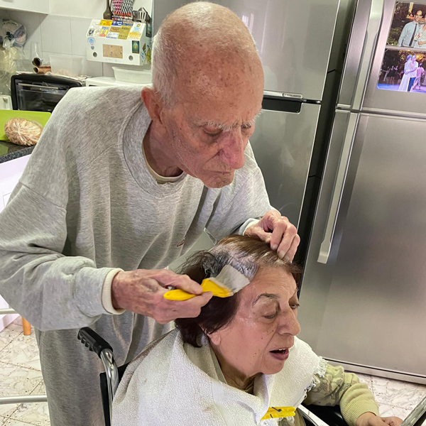 Elderly husband colors wife's hair so she feel well groomed