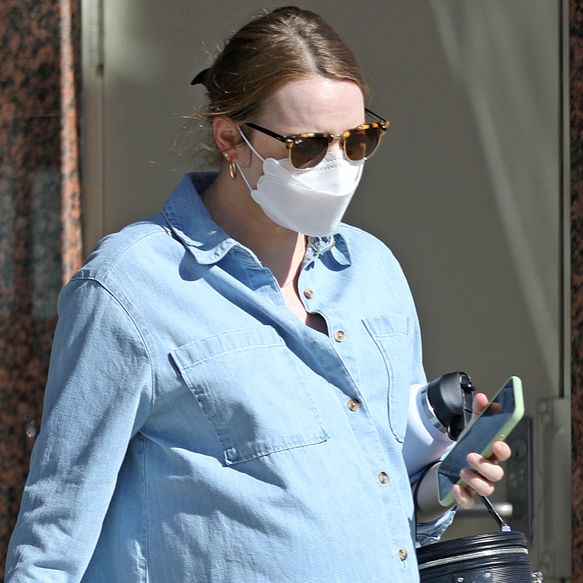 Emma Stone shows her tummy during a tour in Los Angeles