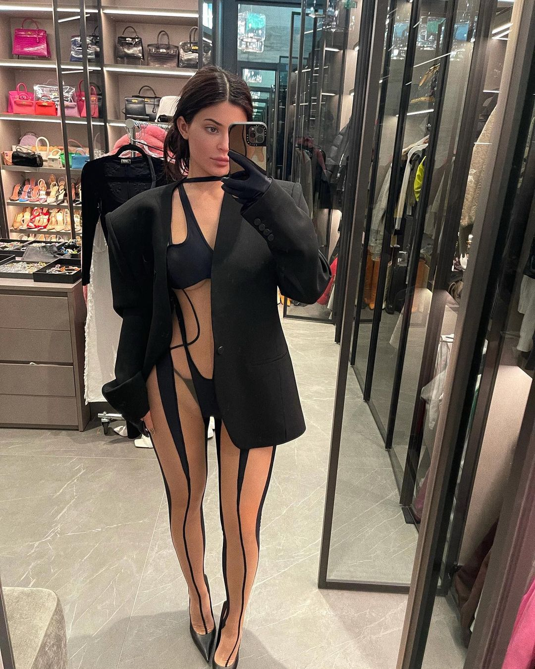 Kylie Jenner flashes skin in Louis Vuitton monokini and scarf