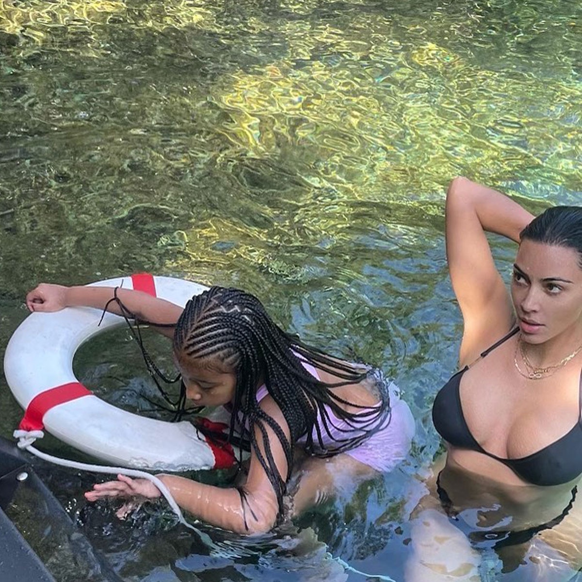 Kim Kardashian Shows Some SKKN in White Bikini During Beach Vacation