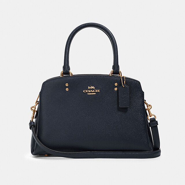 coach bolsas under 100