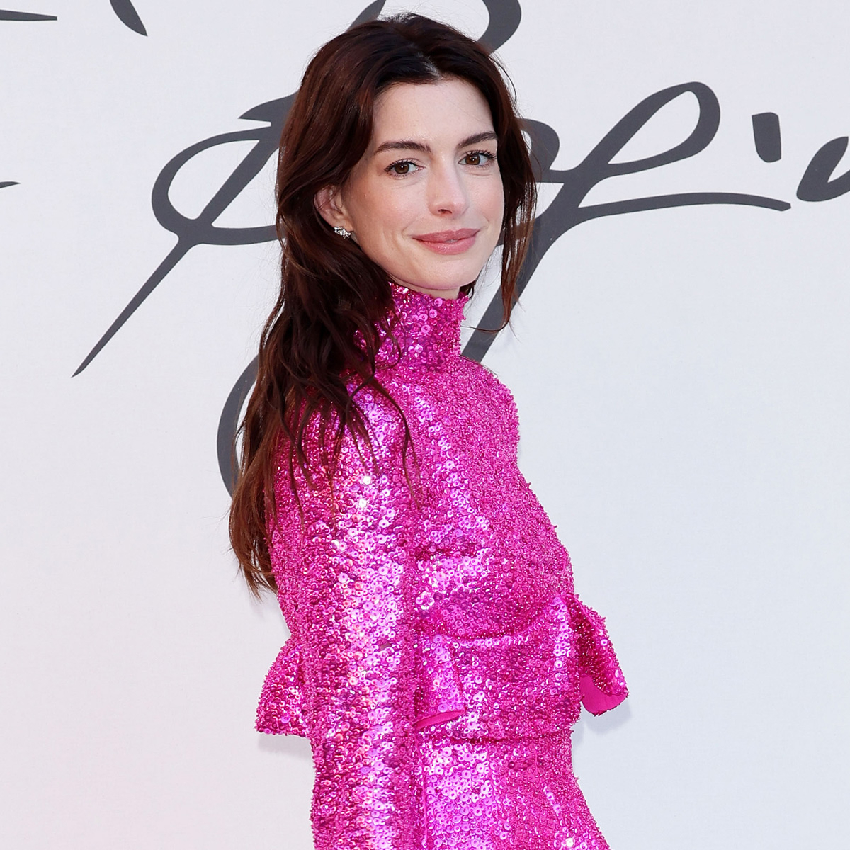Anne Hathaway Wears a Barbie Pink Mini Dress at Valentino's Haute