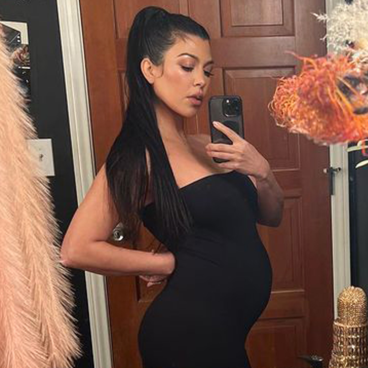 Pregnant Kourtney Kardashian shows off her big bare bump in just a