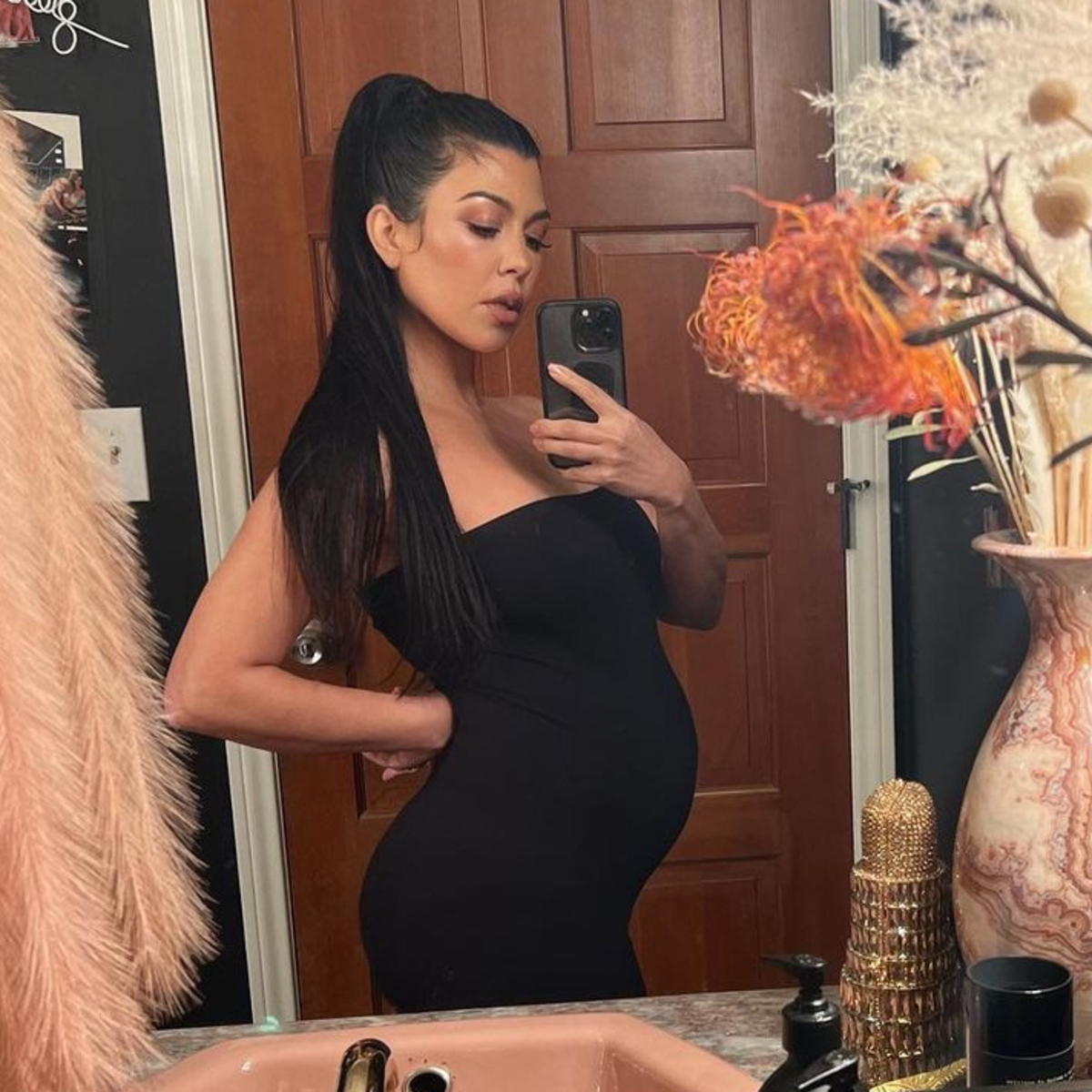 See Travis Barker Cuddled Up on Pregnant Kourtney Kardashian’s Bump