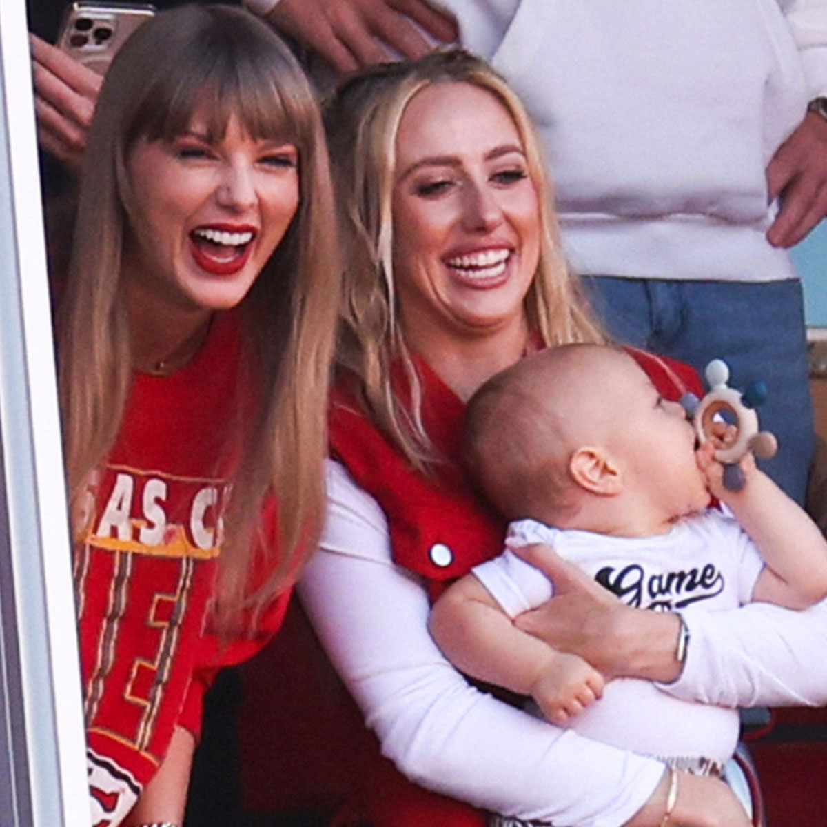 Taylor Swift wears her heart on her sweatshirt in Kansas City Chiefs merch  while cheering lover Travis Kelce's win and even picks up new bestie  Brittany Mahomes in giddy celebration