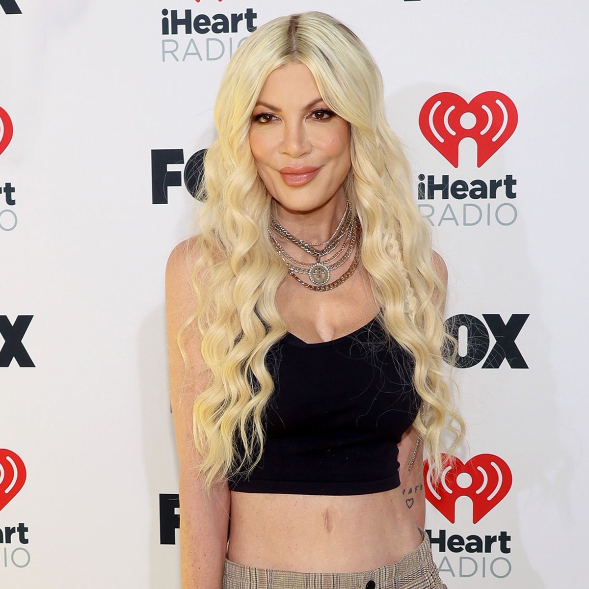 
                        Tori Spelling Debuts Stomach Piercings She Got as a Gift From Her Kids
                