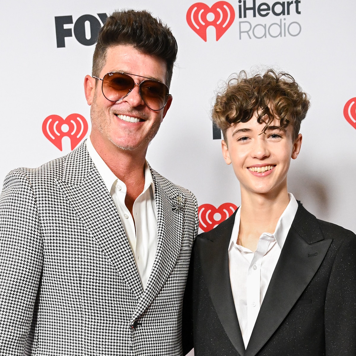 Julian Fuego Thicke makes a rare red carpet appearance alongside dad Robin Thicke at the iHeartRadio Music Awards 2025.