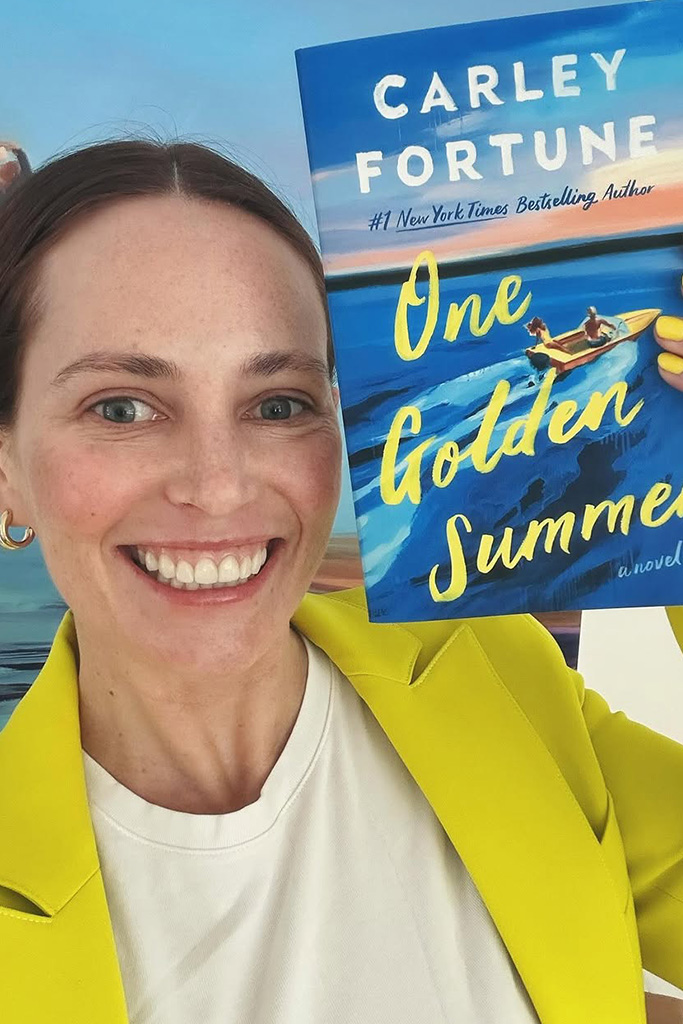 Carley Fortune holding her book One Golden Summer