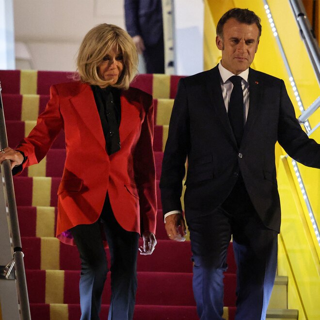 France's President Emmanuel Macron and his wife Brigitte Macron disembark from the plane upon their arrival at Noi Bai International Airport in Hanoi