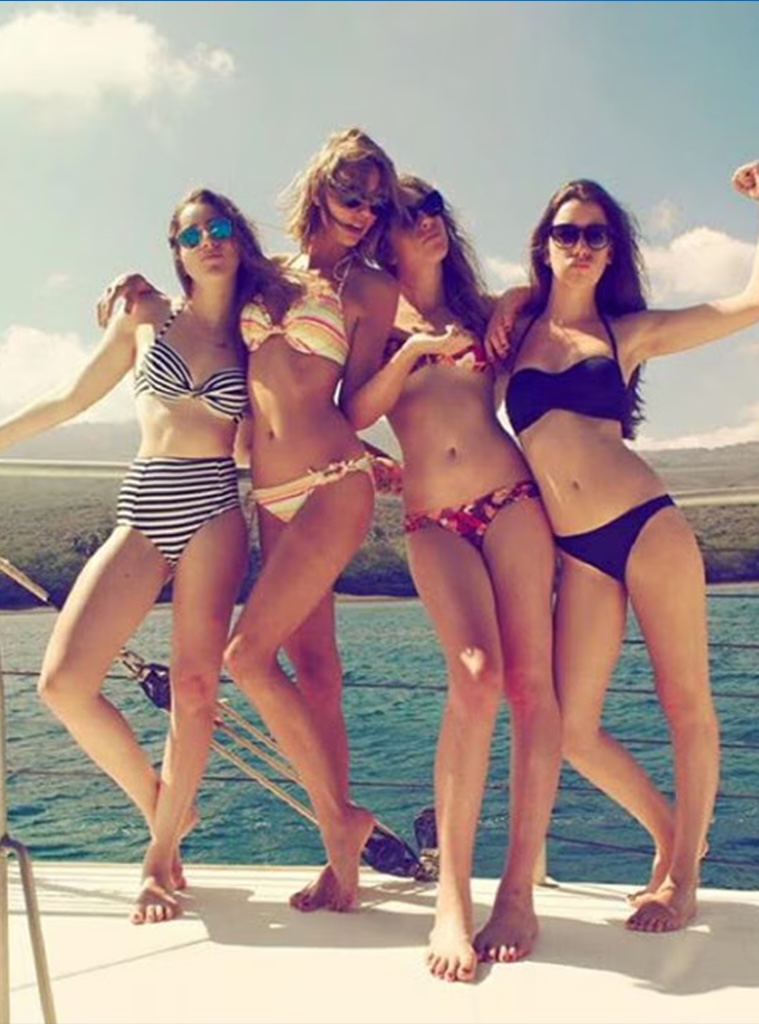 Taylor Swift reveals her belly button.