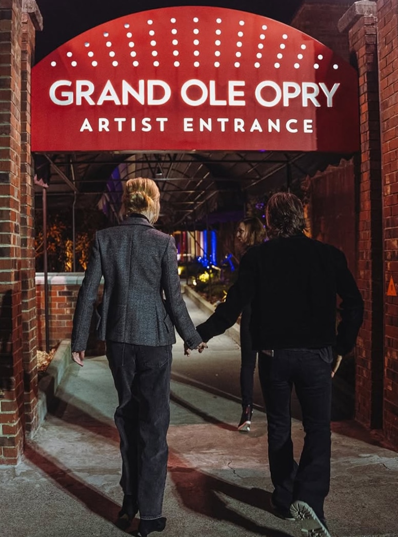 Keith Urban and Nicole Kidman enter the Grand Ole Opry while holding hands.