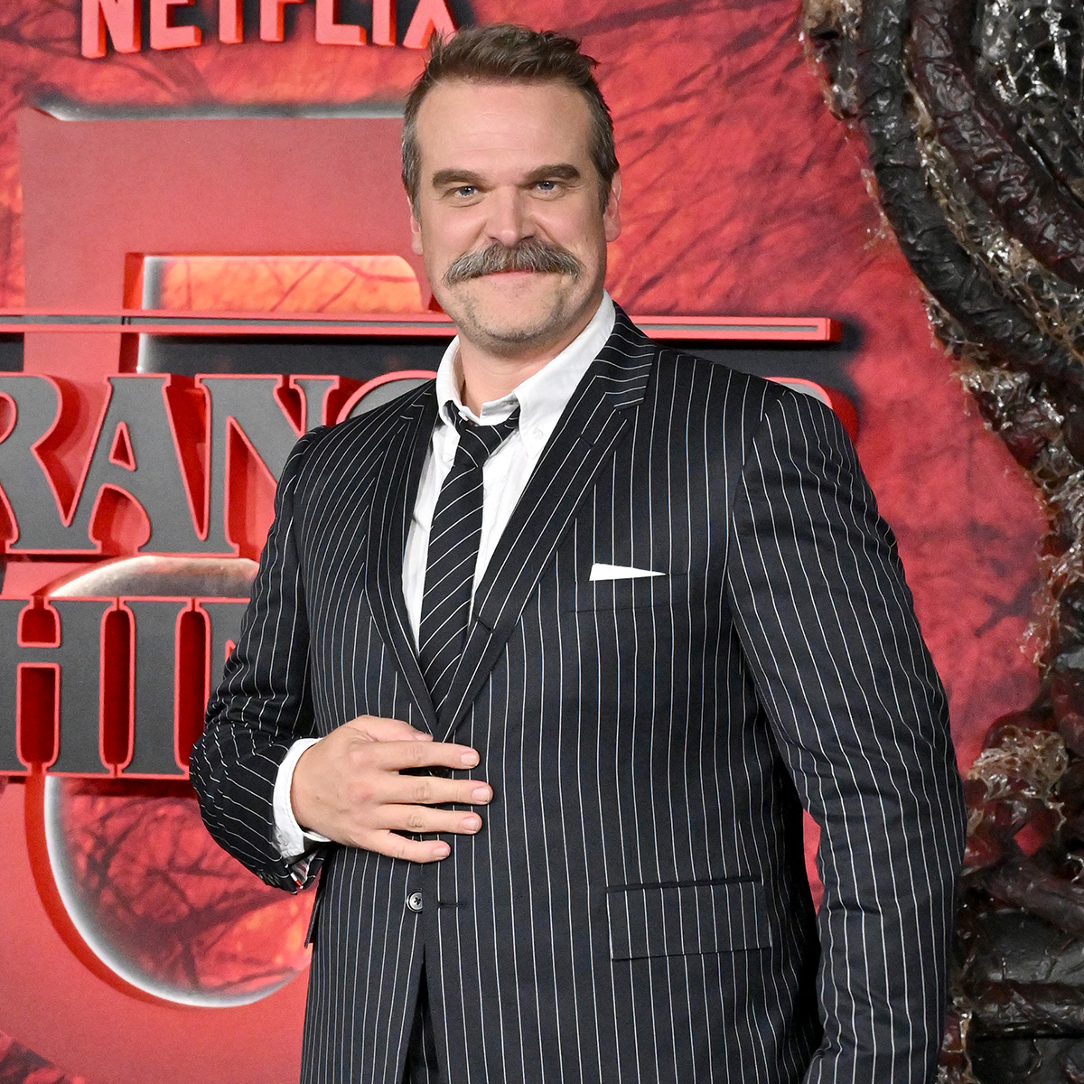 David Harbour with grey hair on set of Evil Genius