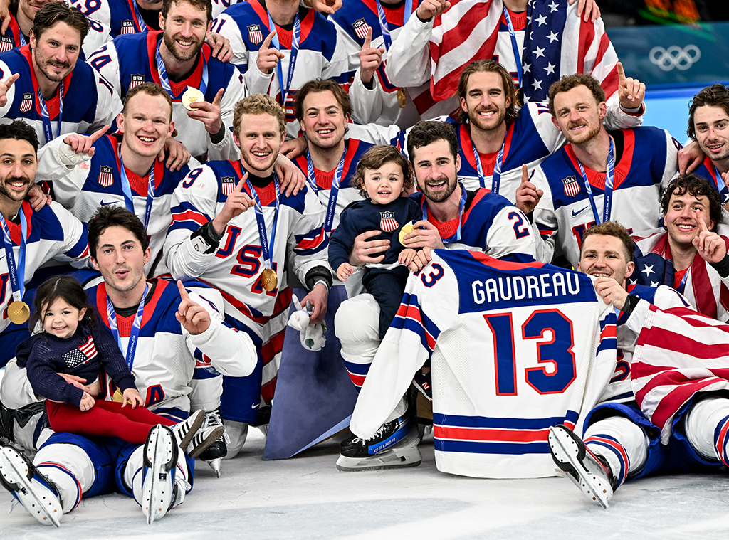 Team USA group photo with Johnny Gaudreau's children Noa and Johnny Jr at 2026 Olympics