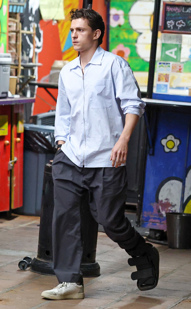 Tom Holland wearing orthopedic boot on his foot